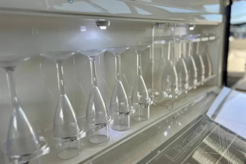 Slide: The Image of Wine glasses neatly stored on the 2024 NX Boats 370 HT. - 49