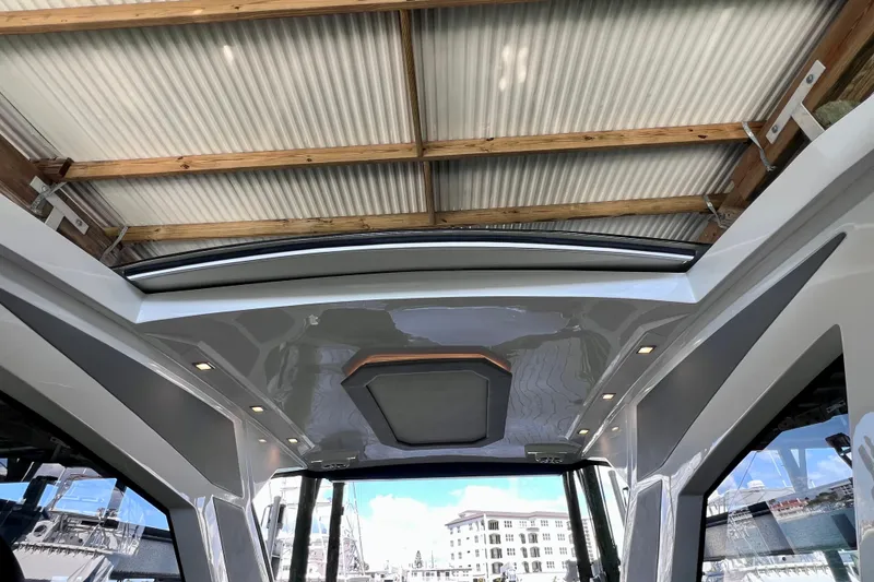 Slide: The Image of 2024 NX Boats 370 HT interior view with modern design and skylight. - 56