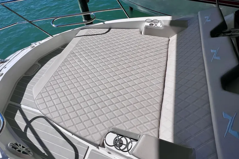 Slide: The Image of Luxurious deck of 2024 NX Boats 370 HT with quilted seating and cup holders. - 62