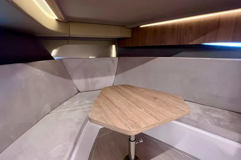 Slide: The Image of 2024 NX Boats 370 HT interior with cozy seating and wooden table. - 68