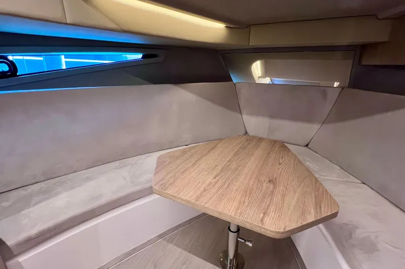 Slide: The Image of 2024 NX Boats 370 HT interior with cozy seating and wooden table. - 69