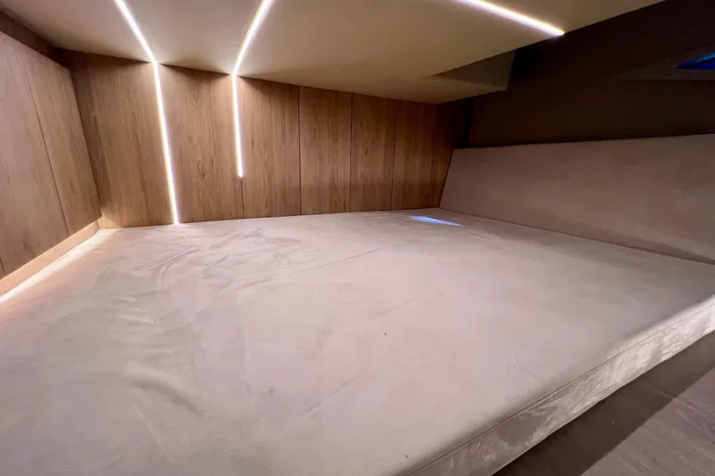 Slide: The Image of 2024 NX Boats 370 HT cabin interior with modern lighting and wood paneling. - 72