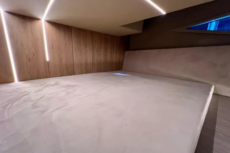 Slide: The Image of Luxurious interior cabin of 2024 NX Boats 370 HT with modern lighting and wood paneling. - 73