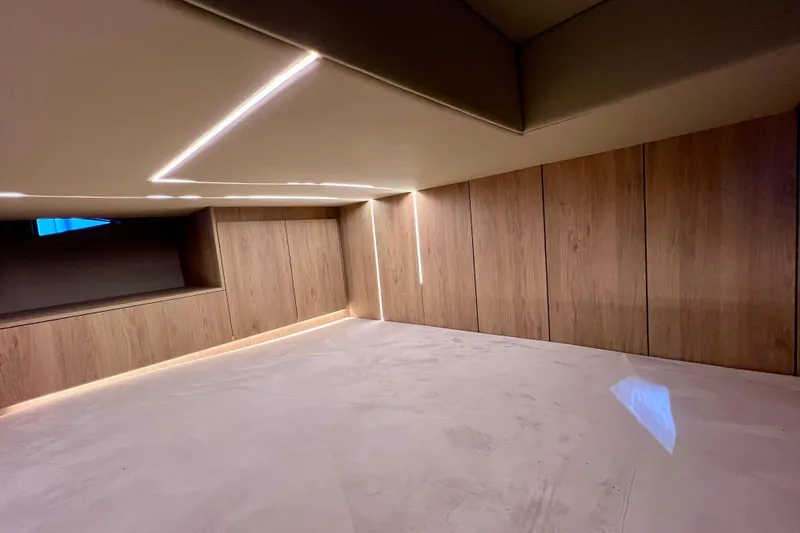 Slide: The Image of Luxurious interior of 2024 NX Boats 370 HT with modern wood paneling and ambient lighting. - 74
