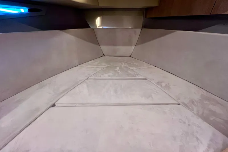 Slide: The Image of 2024 NX Boats 370 HT interior cabin with plush seating and modern design. - 78