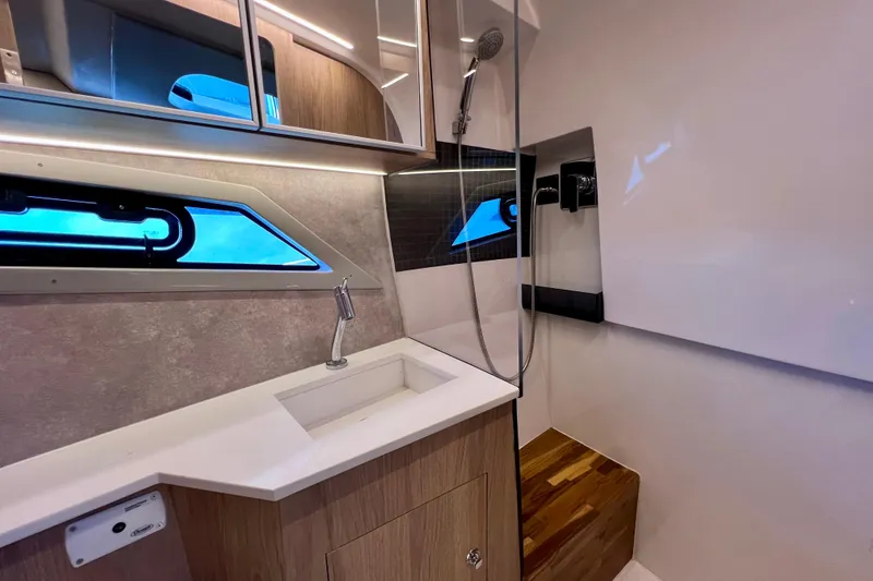 Slide: The Image of 2024 NX Boats 370 HT bathroom with modern sink, shower, and sleek design. - 81