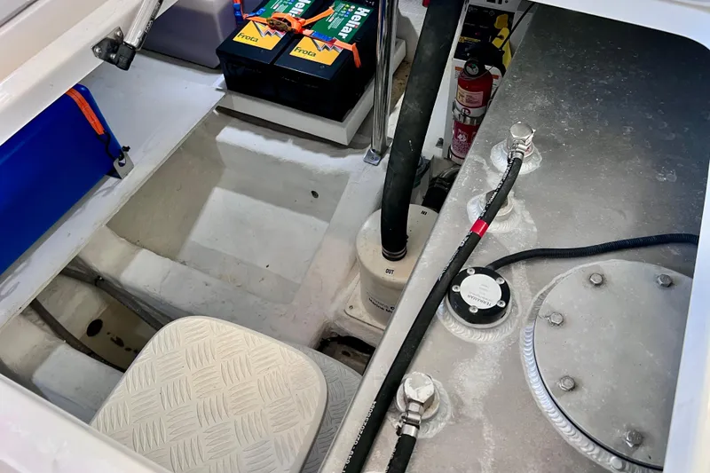 Slide: The Image of 2024 NX Boats 370 HT engine compartment with batteries and fire extinguisher. - 83