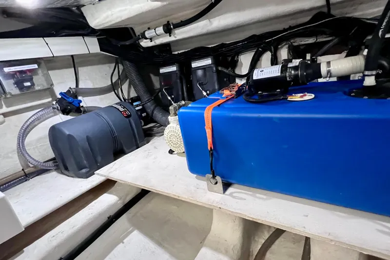 Slide: The Image of 2024 NX Boats 370 HT engine room with blue tank and equipment. - 88