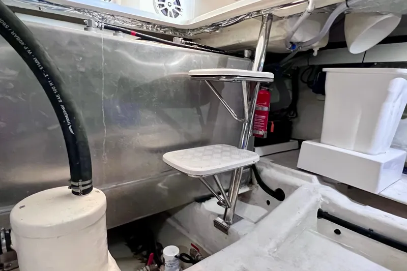 Slide: The Image of 2024 NX Boats 370 HT engine room with ladder and fire extinguisher. - 90