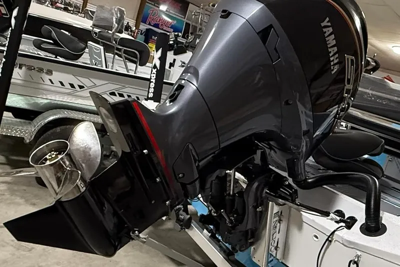 Slide: The Image of 2026 Express H22 Bay boat with Yamaha outboard motor in showroom. - 10