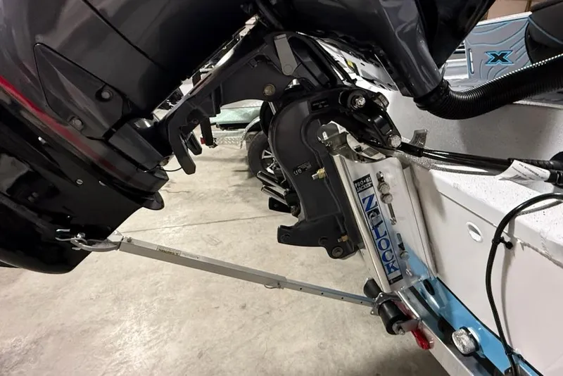 Slide: The Image of 2026 Express H22 Bay boat motor and hydraulic system in a garage setting. - 11