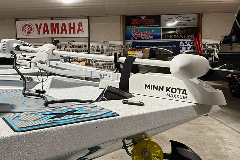 Slide: The Image of 2026 Express H22 Bay boat with Minn Kota Maxxum trolling motor in showroom. - 12
