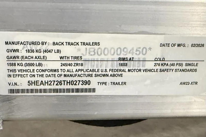 Slide: The Image of Trailer label showing specifications, including GVWR, GAWR, tire size, and VIN for 2026 Express H22 Bay. - 19