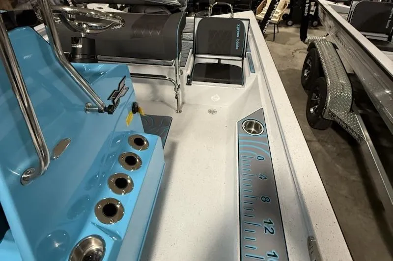 Slide: The Image of 2026 Express H22 Bay boat interior with blue console, seating, and measurement markings. - 3