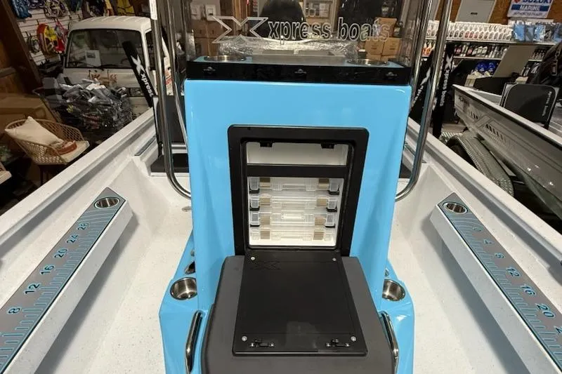 Slide: The Image of 2026 Express H22 Bay boat interior with storage compartment and measuring scale. - 6