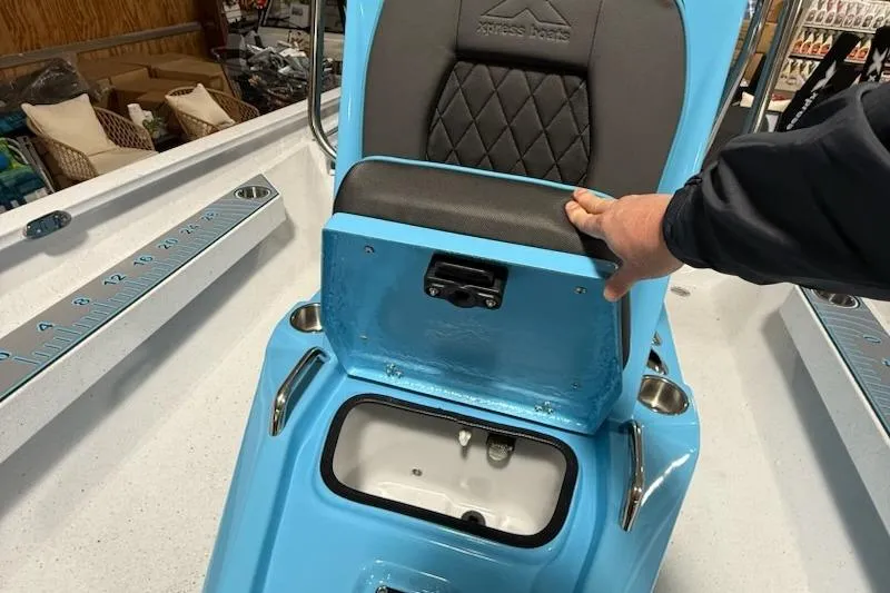 Slide: The Image of 2026 Express H22 Bay boat seat with storage compartment open, showcasing interior features. - 7