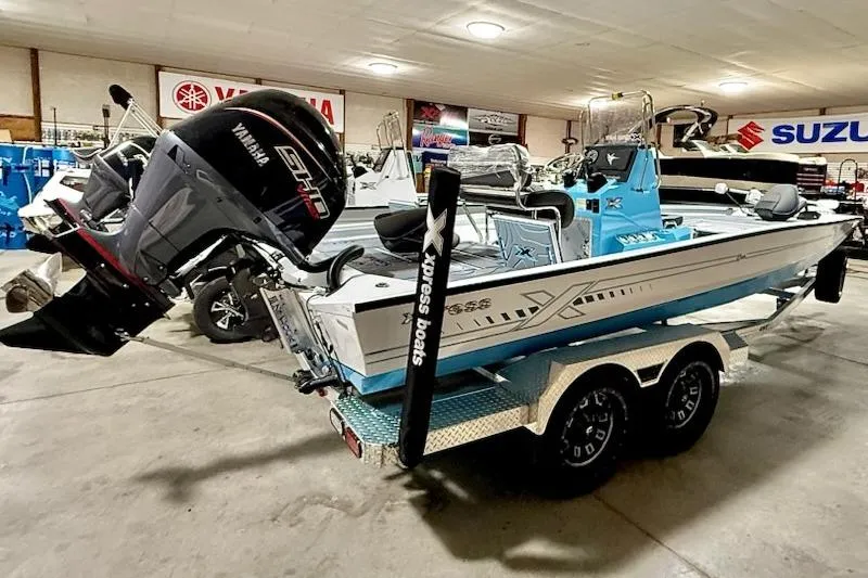 Slide: The Image of 2026 Express H22 Bay boat with Yamaha engine on trailer in showroom. - 8