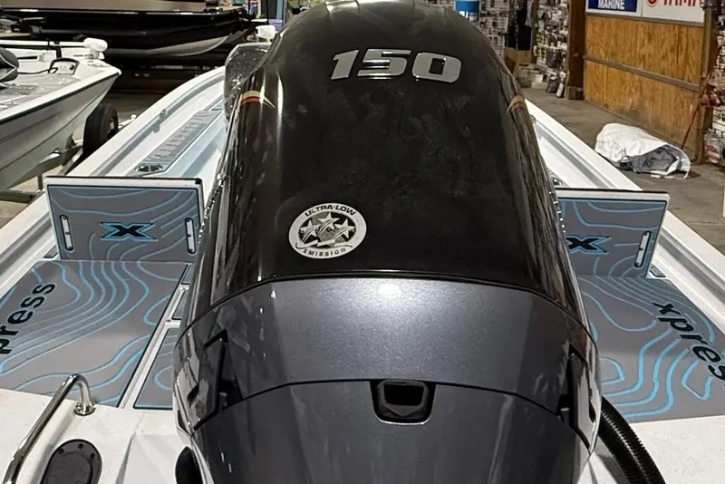 Slide: The Image of 2026 Express H22 Bay boat with 150 horsepower engine in showroom. - 9