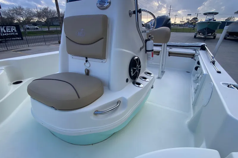 Slide: The Image of 2018 NauticStar 215 XTS boat interior with seating and console details. - 11