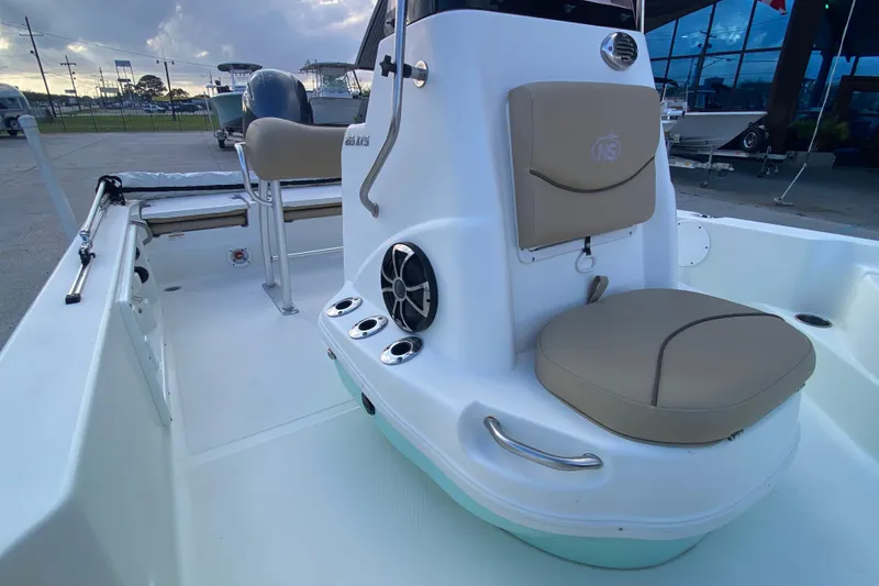 Slide: The Image of 2018 NauticStar 215 XTS boat interior with seating and console details. - 12
