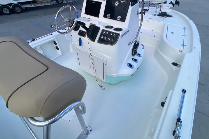 Slide: The Image of 2018 NauticStar 215 XTS boat interior with steering console and seating. - 13