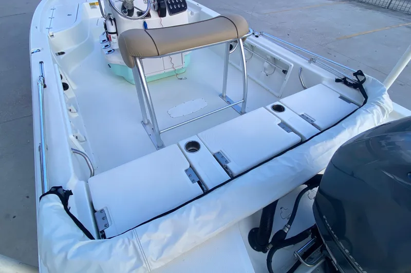 Slide: The Image of 2018 NauticStar 215 XTS boat interior with seating and console. - 18