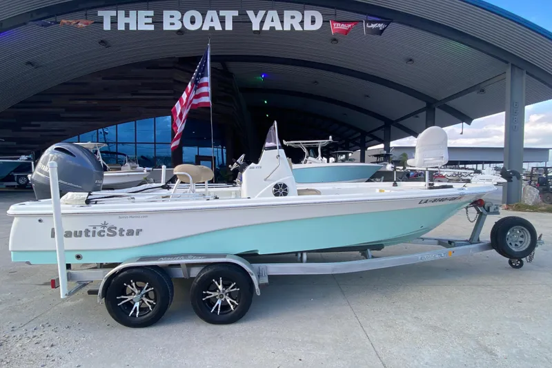 Slide: The Image of 2018 NauticStar 215 XTS boat on trailer at The Boat Yard dealership. - 4