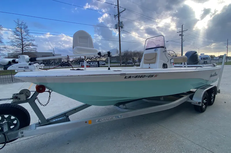 Slide: The Image of 2018 NauticStar 215 XTS boat on trailer, under cloudy sky. - 7