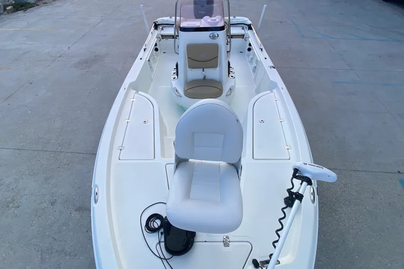 Slide: The Image of 2018 NauticStar 215 XTS boat interior with seating and trolling motor. - 9