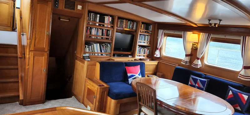 Slide: The Image of Luxurious 1983 Thackwray Custom Pilothouse Motorsailer interior with wood finish and cozy seating. - 11