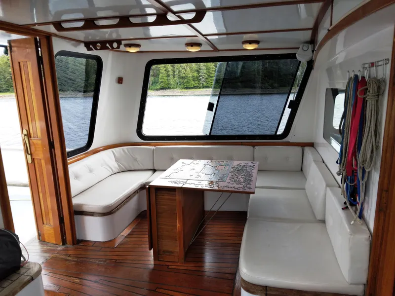 Slide: The Image of Interior of 1983 Thackwray Custom Pilothouse Motorsailer with wooden accents and large windows. - 2