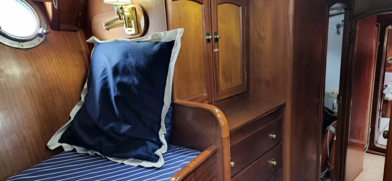 Slide: The Image of Cozy cabin interior of 1983 Thackwray Custom Pilothouse Motorsailer with wooden furnishings and nautical decor. - 26