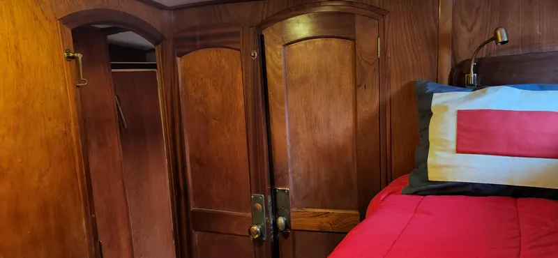 Slide: The Image of Wood-paneled cabin interior of 1983 Thackwray Custom Pilothouse Motorsailer with bed and closet. - 28