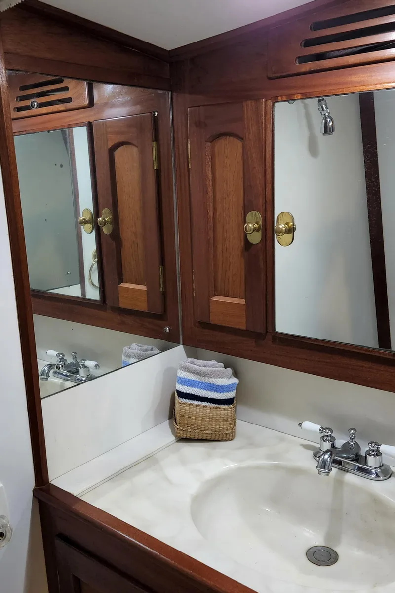 Slide: The Image of Wooden bathroom vanity with mirrors in 1983 Thackwray Custom Pilothouse Motorsailer. - 30