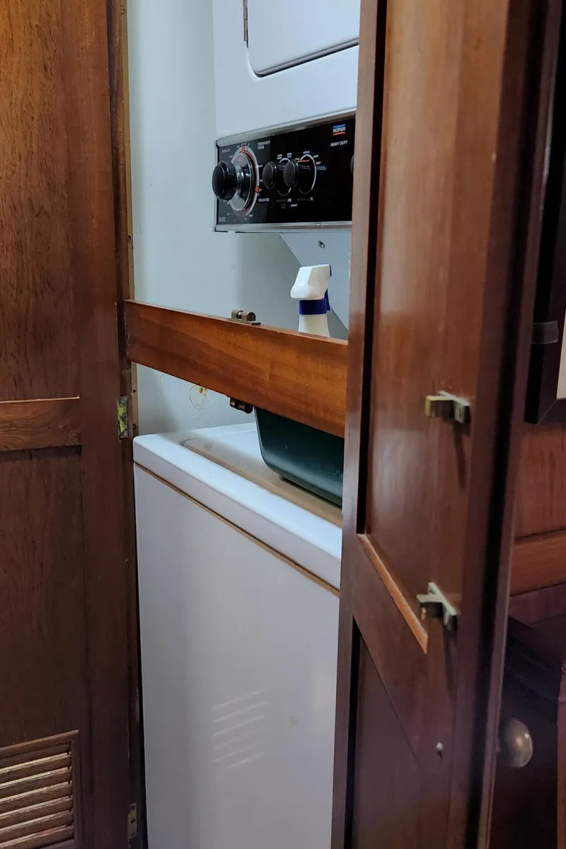 Slide: The Image of Laundry area inside 1983 Thackwray Custom Pilothouse Motorsailer with wooden cabinetry. - 32