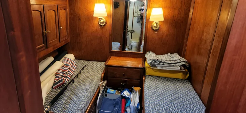 Slide: The Image of Cozy cabin interior of 1983 Thackwray Custom Pilothouse Motorsailer with wooden furnishings and twin beds. - 38