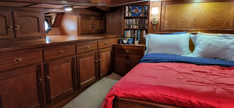Slide: The Image of Luxurious 1983 Thackwray Custom Pilothouse Motorsailer cabin with wood paneling and cozy bedding. - 42