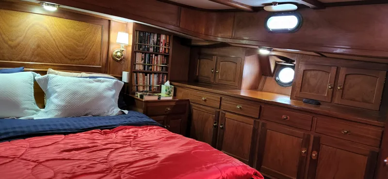 Slide: The Image of Luxurious cabin interior of 1983 Thackwray Custom Pilothouse Motorsailer with wood paneling and cozy bedding. - 43