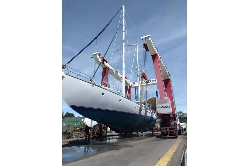 Slide: The Image of 1983 Thackwray Custom Pilothouse Motorsailer being lifted by crane at shipyard. - 73