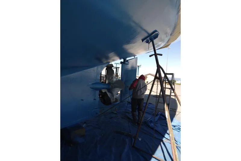 Slide: The Image of Workers painting the hull of a 1983 Thackwray Custom Pilothouse Motorsailer. - 76