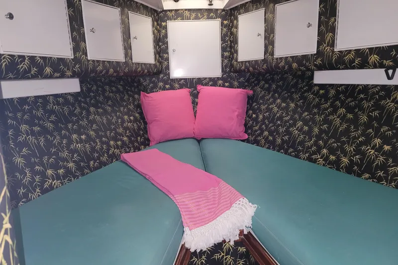 Slide: The Image of Cozy cabin interior of 1984 Sunny Briggs 37 Express with vibrant decor and storage cabinets. - 12