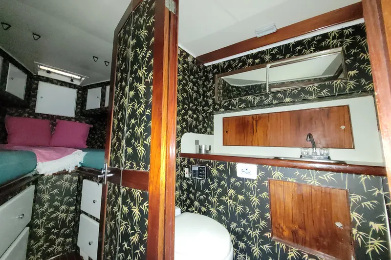 Slide: The Image of 1984 Sunny Briggs 37 Express cabin interior with floral wallpaper and wooden accents. - 13