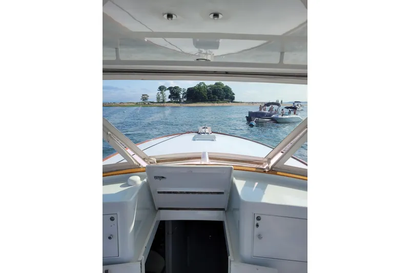 Slide: The Image of View from 1984 Sunny Briggs 37 Express boat, overlooking water and nearby island. - 7