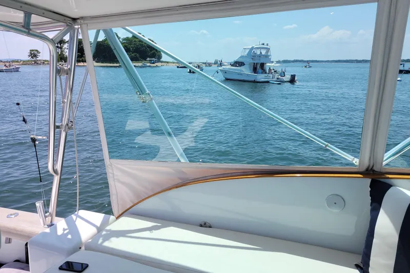 Slide: The Image of 1984 Sunny Briggs 37 Express yacht on serene water with scenic island view. - 8