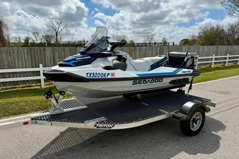 The Image of 2022 Sea-Doo FishPro Sport 170 on trailer, parked outdoors under cloudy sky. - 1