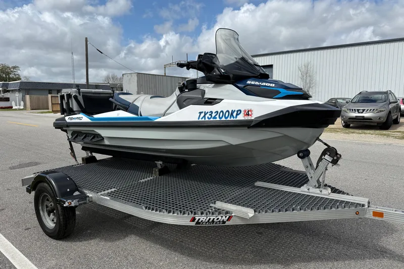 Slide: The Image of 2022 Sea-Doo FishPro Sport 170 on trailer, parked outdoors under cloudy sky. - 5