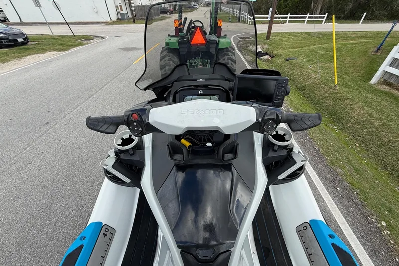 Slide: The Image of 2022 Sea-Doo FishPro Sport 170 on road, handlebars view, with tractor ahead. - 9