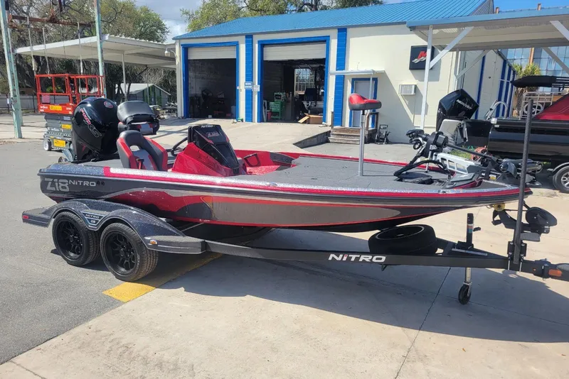 The Image of 2026 Nitro Z18 boat with trailer, parked outside a workshop. - 1