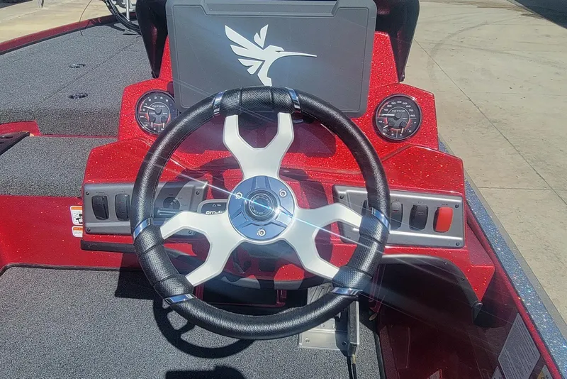 Slide: The Image of Steering wheel of a 2026 Nitro Z18 boat with red dashboard and gauges. - 13