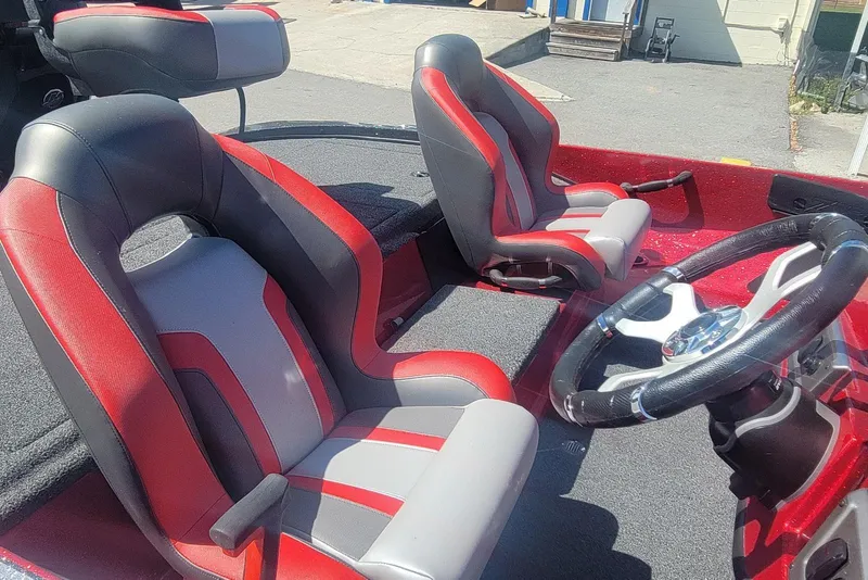 Slide: The Image of 2026 Nitro Z18 boat interior with red and gray seats and steering wheel. - 14